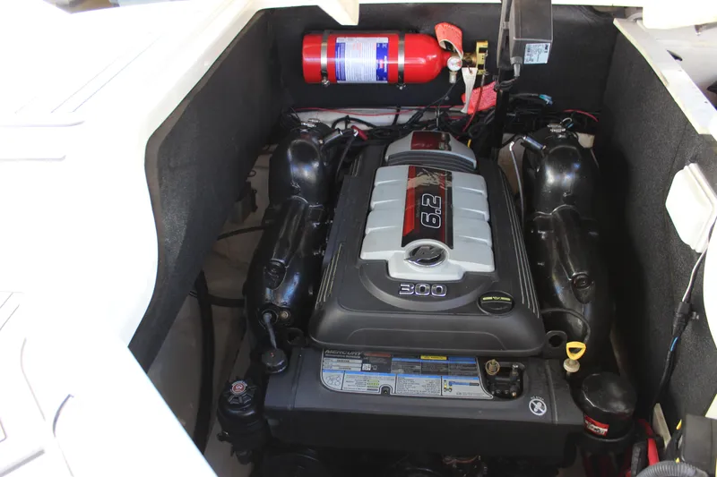 Slide: The Image of 2016 Sea Ray 250 SLX engine compartment with fire extinguisher. - 24