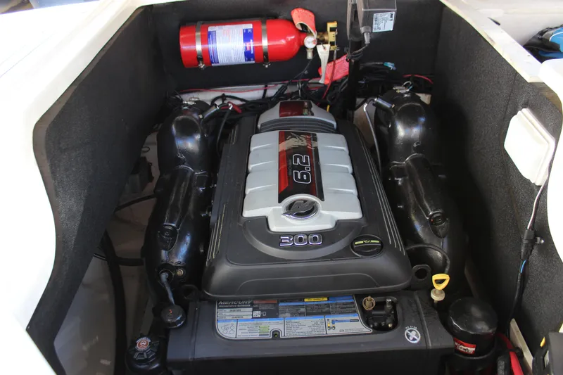 Slide: The Image of 2016 Sea Ray 250 SLX engine compartment with fire extinguisher. - 26