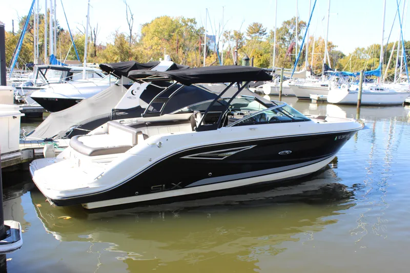 Slide: The Image of 2016 Sea Ray 250 SLX boat docked in a marina with other vessels. - 4