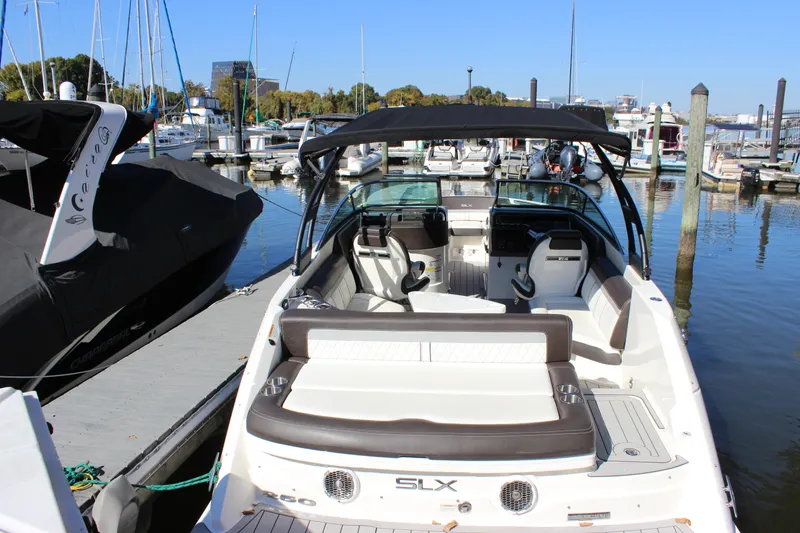 Slide: The Image of 2016 Sea Ray 250 SLX boat docked at marina, rear view. - 5