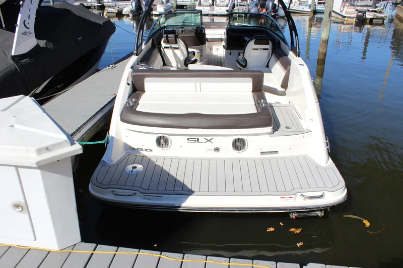 Slide: The Image of 2016 Sea Ray 250 SLX boat docked at marina, rear view. - 6