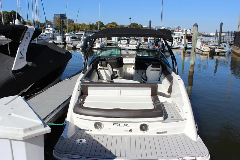 Slide: The Image of 2016 Sea Ray 250 SLX boat docked at marina, rear view. - 7