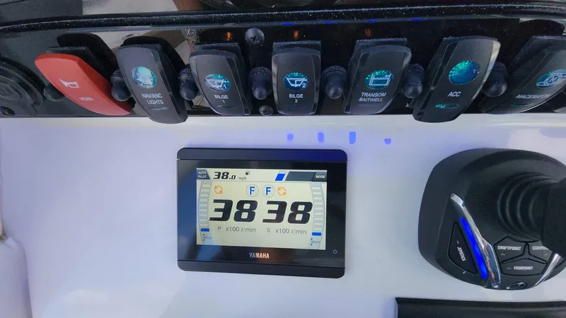 Slide: The Image of Control panel of 2024 Sea Hunt Ultra 275 SE with digital display and switches. - 29