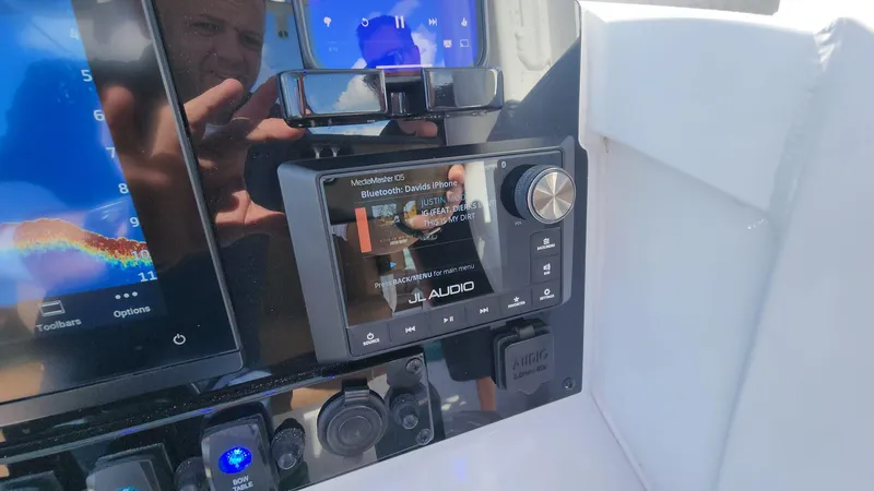 Slide: The Image of 2024 Sea Hunt Ultra 275 SE dashboard with JL Audio system and digital displays. - 30