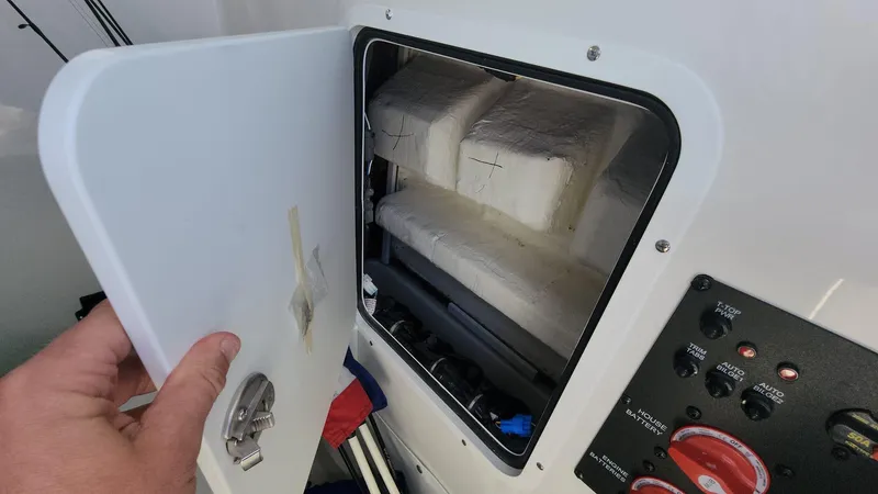 Slide: The Image of 2024 Sea Hunt Ultra 275 SE storage compartment with control panel. - 31