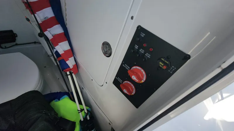 Slide: The Image of Control panel inside 2024 Sea Hunt Ultra 275 SE boat with American flag and safety gear. - 33