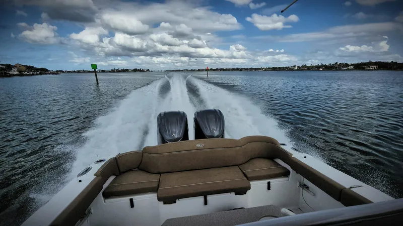 Slide: The Image of 2024 Sea Hunt Ultra 275 SE cruising on open water, showcasing powerful dual engines. - 4