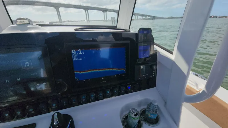 Slide: The Image of 2024 Sea Hunt Ultra 275 SE dashboard with navigation display on the water. - 40