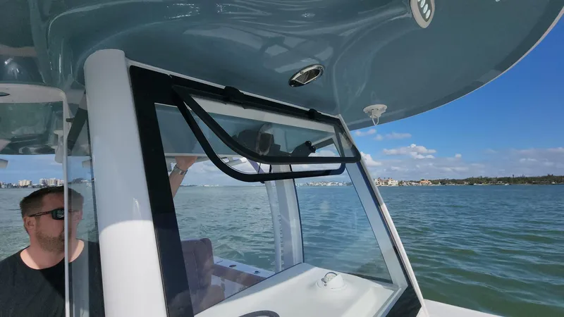 Slide: The Image of 2024 Sea Hunt Ultra 275 SE on water, featuring sleek design and spacious cabin. - 42