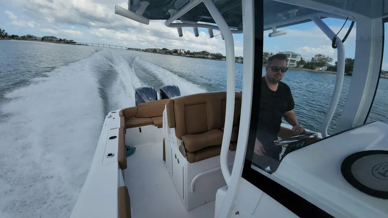 Slide: The Image of 2024 Sea Hunt Ultra 275 SE cruising on a scenic waterway. - 44