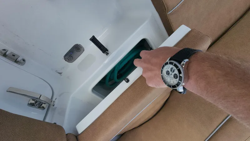 Slide: The Image of Person opening storage compartment on 2024 Sea Hunt Ultra 275 SE boat. - 47