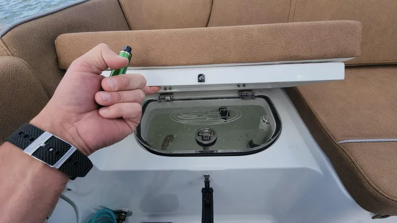 Slide: The Image of 2024 Sea Hunt Ultra 275 SE boat with open storage compartment. - 49