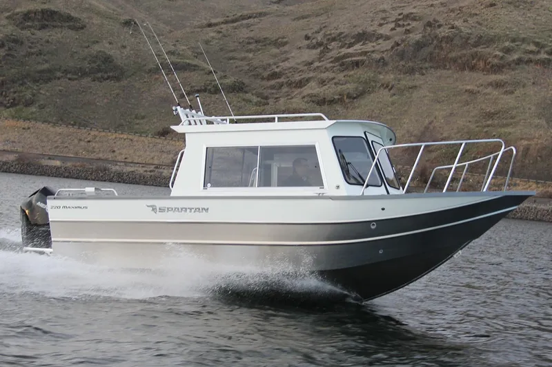 Slide: The Image of 2024 Spartan 220 Maximus boat cockpit with steering wheel and control panel. - 15