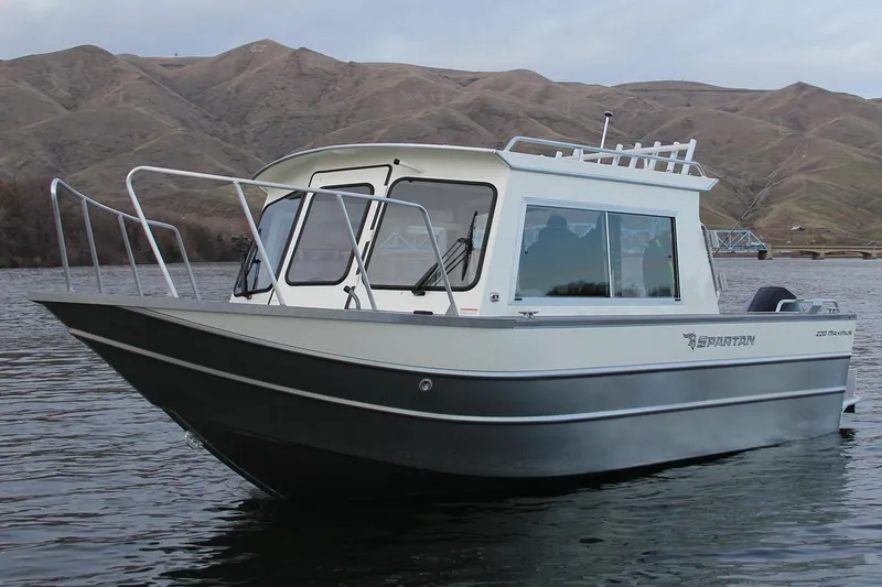 Slide: The Image of 2024 Spartan 220 Maximus boat cockpit with steering wheel and control panel. - 16