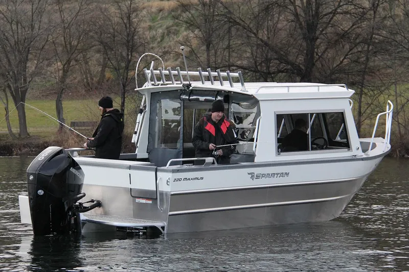 Slide: The Image of 2024 Spartan 220 Maximus boat interior with steering wheel and storage compartments. - 18