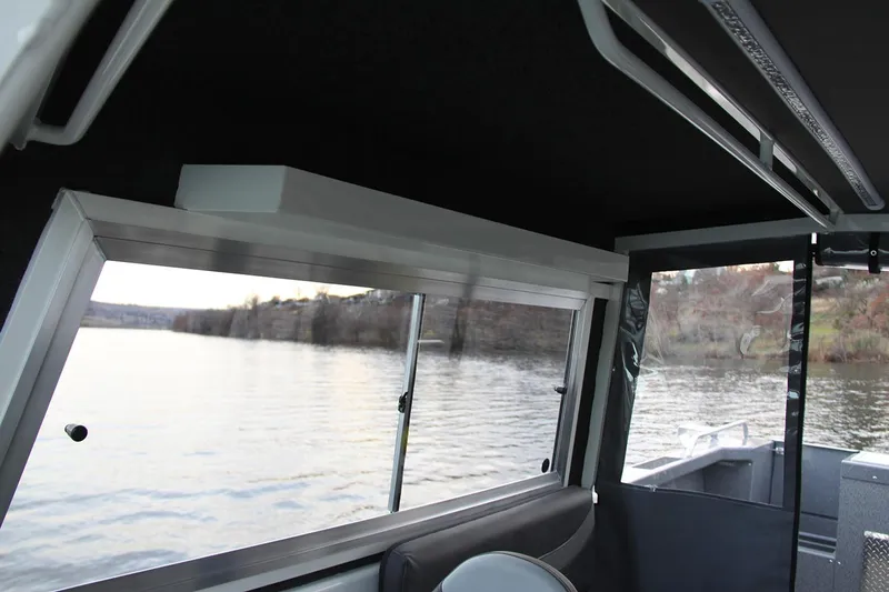 Slide: The Image of 2024 Spartan 220 Maximus boat deck with non-slip surface and storage hatch. - 28