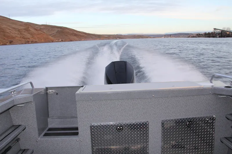 Slide: The Image of 2024 Spartan 220 Maximus boat interior with seating and open doors, showcasing modern design. - 30