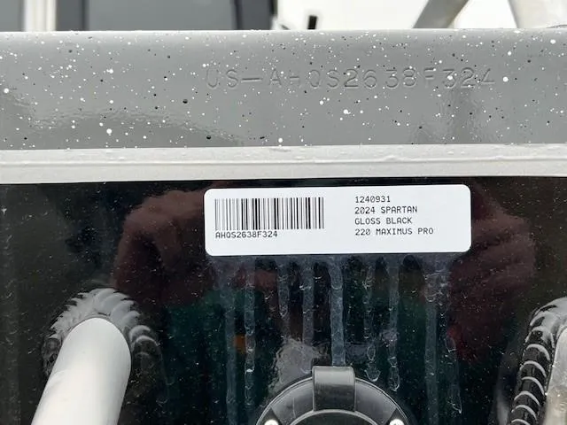 Slide: The Image of 2024 Spartan 220 Maximus boat on trailer, parked on a road. - 9