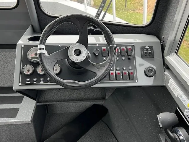 Slide: The Image of 2024 Spartan 220 Maximus boat dashboard with steering wheel and control panel. - 3