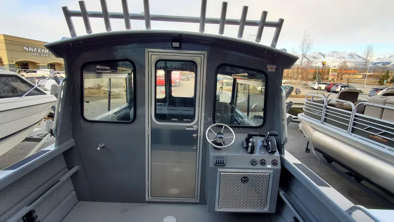 Slide: The Image of 2023 Spartan 220 Maximus boat interior with steering wheel and control panel. - 6