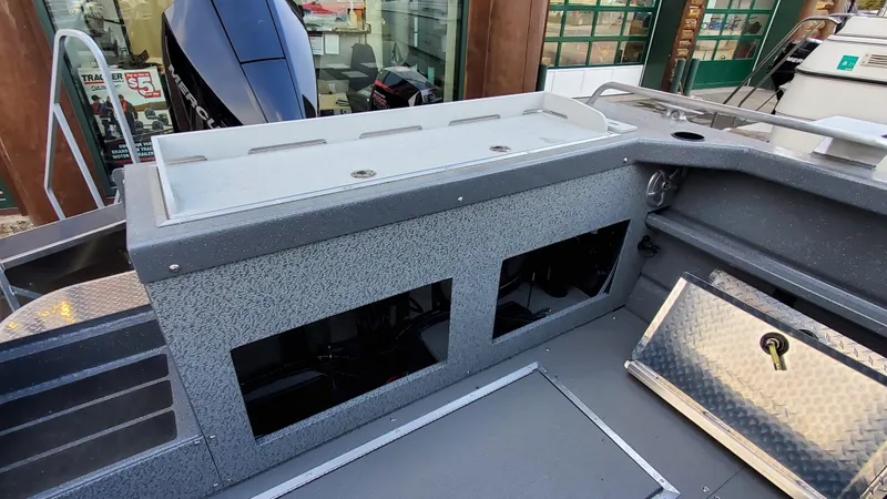 Slide: The Image of 2023 Spartan 220 Maximus boat interior with storage compartments and modern design. - 8