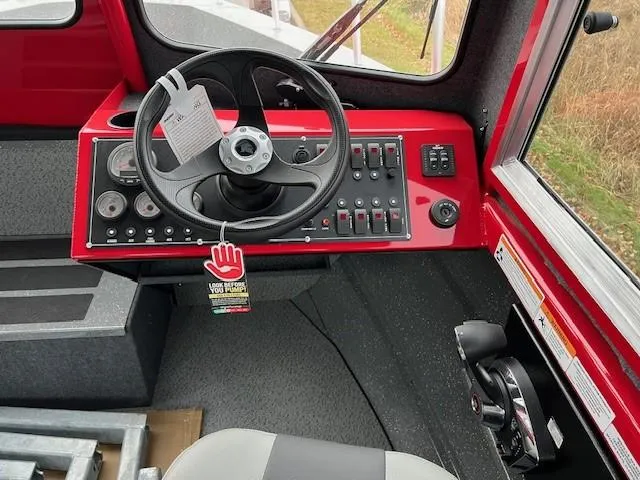 Slide: The Image of 2024 Spartan 220 Maximus dashboard with steering wheel and control panel. - 7