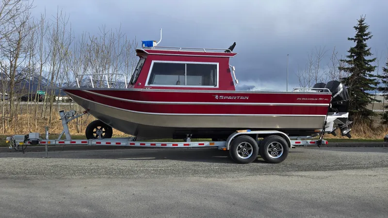 The Image of 2024 Spartan 24 MAXIMUS PRO XL boat on trailer, parked outdoors. - 0