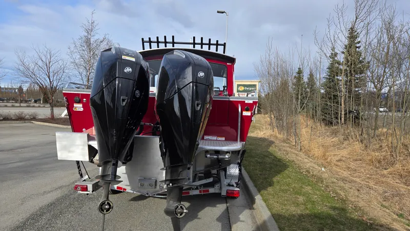 Slide: The Image of 2024 Spartan 24 MAXIMUS PRO XL boat with dual outboard motors, parked on a roadside. - 3