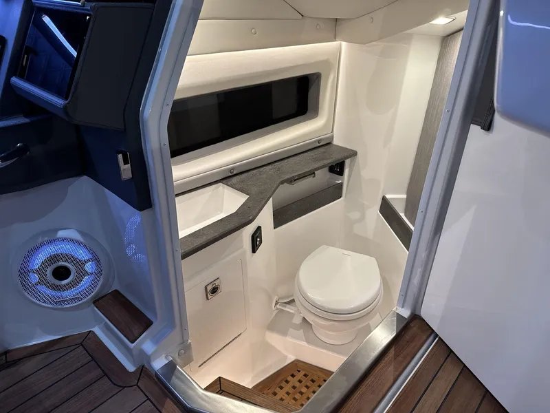 Slide: The Image of 2025 Cobalt R35 boat interior bathroom with modern design and wooden flooring. - 10