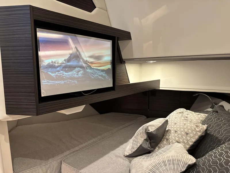 Slide: The Image of Luxurious interior of 2025 Cobalt R35 with TV and plush bedding. - 12