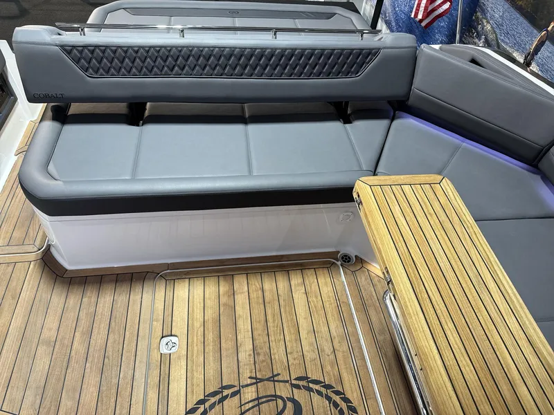 Slide: The Image of Luxury seating area on 2025 Cobalt R35 boat with wooden flooring and table. - 15