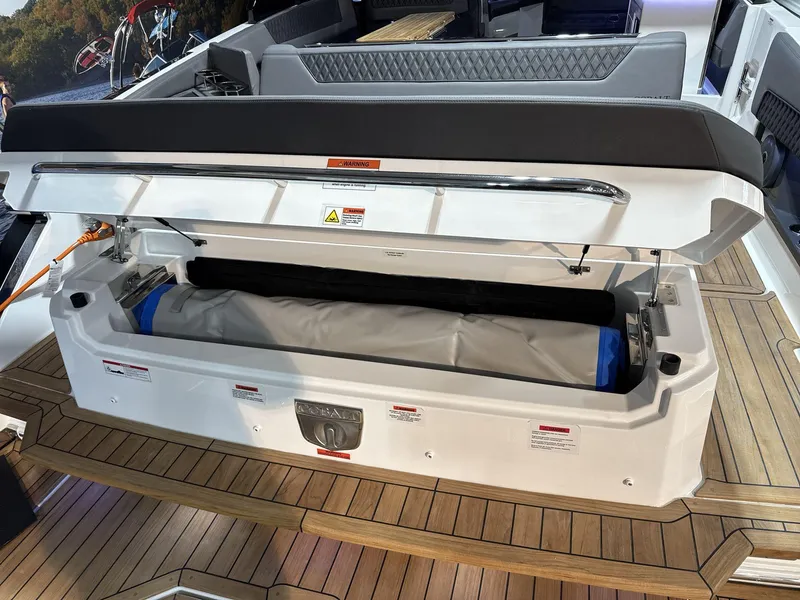 Slide: The Image of 2025 Cobalt R35 boat storage compartment open on teak deck. - 19