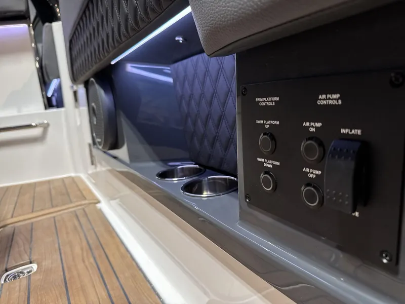 Slide: The Image of Cobalt R35 2025 boat interior with control panel and cup holders. - 20