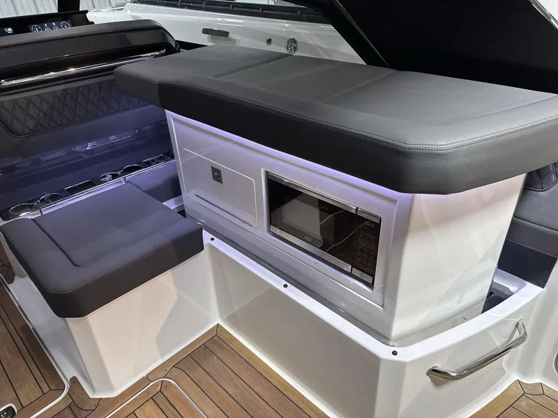 Slide: The Image of 2025 Cobalt R35 boat interior with seating and built-in microwave. - 23