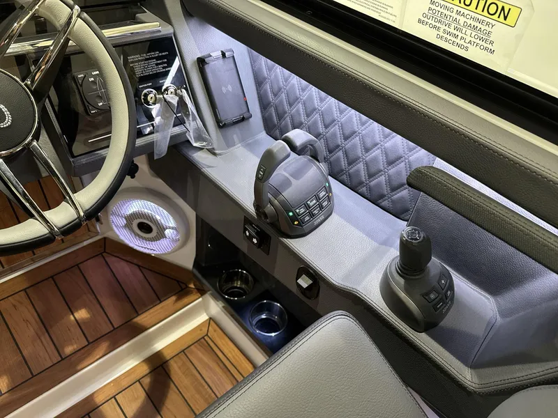 Slide: The Image of 2025 Cobalt R35 boat cockpit with modern controls, steering wheel, and wood flooring. - 8