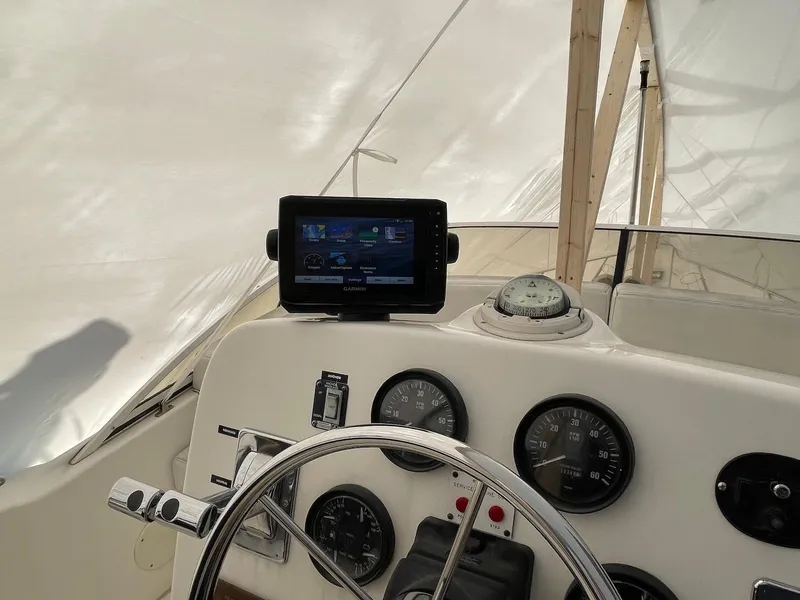 Slide: The Image of 1999 Silverton 351 Sedan Cruiser helm with navigation instruments and steering wheel. - 11