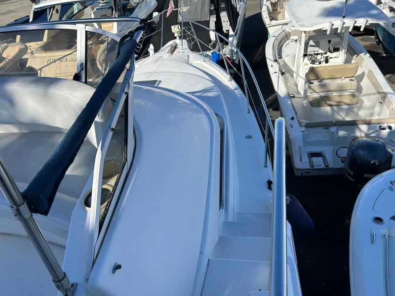 Slide: The Image of 1999 Silverton 351 Sedan Cruiser docked among other boats. - 13