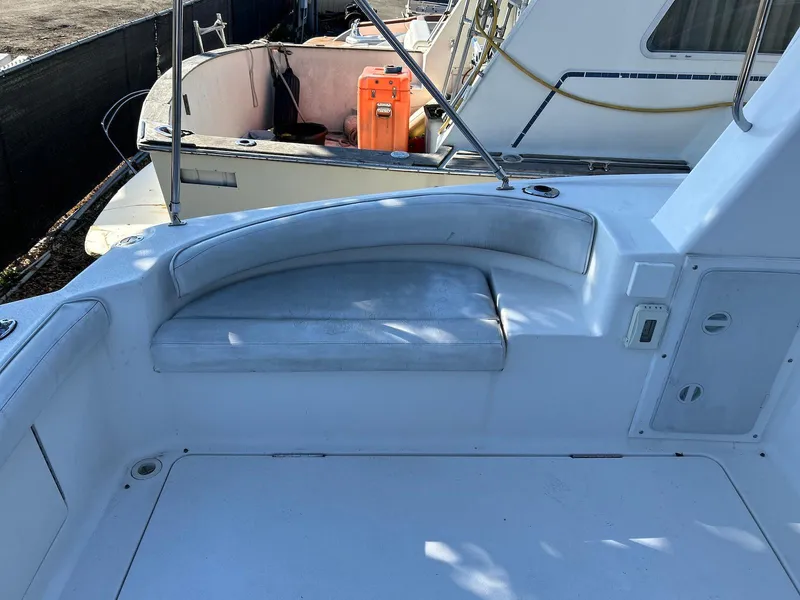 Slide: The Image of 1999 Silverton 351 Sedan Cruiser seating area with white upholstery. - 16