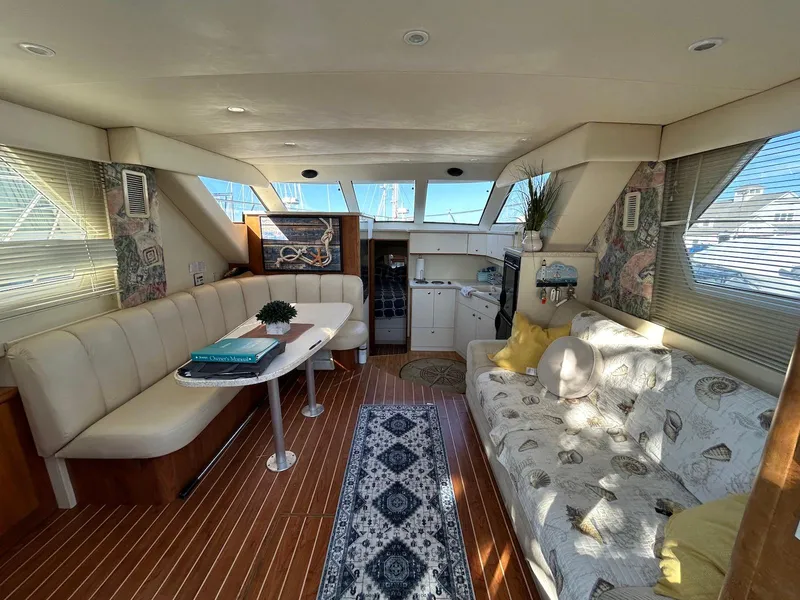 Slide: The Image of Interior of 1999 Silverton 351 Sedan Cruiser with cozy seating and nautical decor. - 17