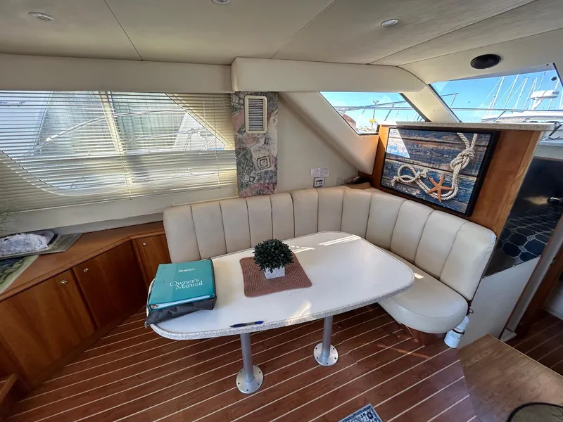Slide: The Image of Interior of 1999 Silverton 351 Sedan Cruiser with cozy seating and nautical decor. - 18
