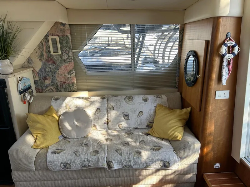 Slide: The Image of Interior of 1999 Silverton 351 Sedan Cruiser with cozy sofa and decorative pillows. - 19