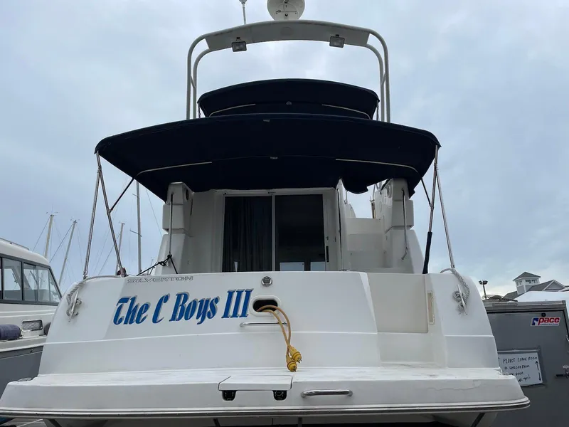 Slide: The Image of 1999 Silverton 351 Sedan Cruiser, rear view with "The C Boys III" name. - 2