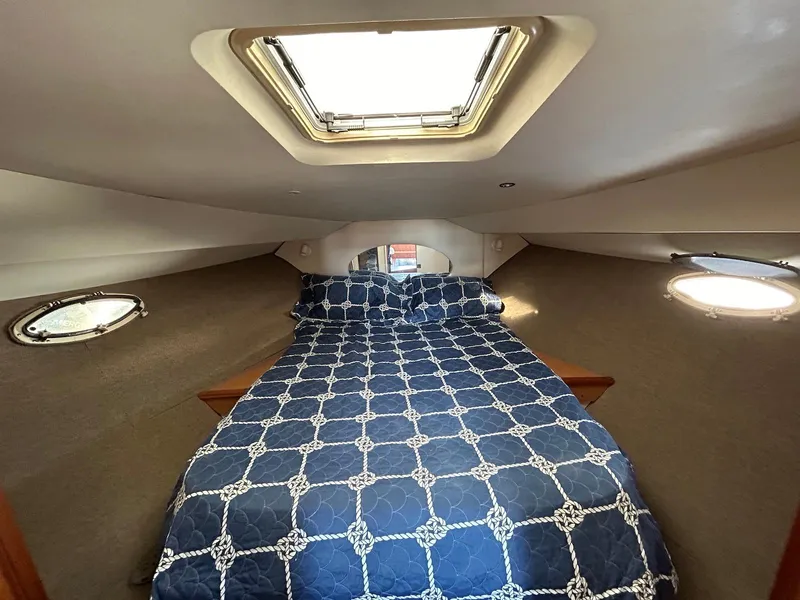 Slide: The Image of Interior cabin of 1999 Silverton 351 Sedan Cruiser with bed and portholes. - 20