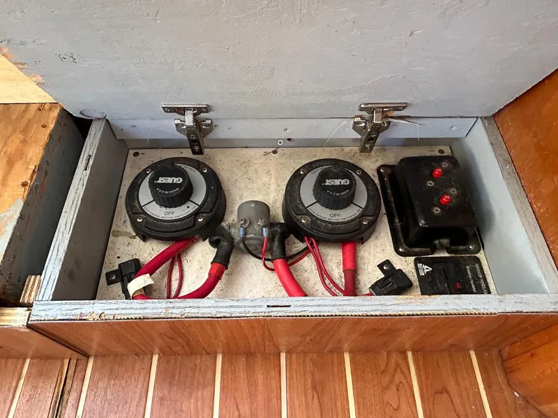 Slide: The Image of 1999 Silverton 351 Sedan Cruiser battery switches and wiring in wooden compartment. - 21