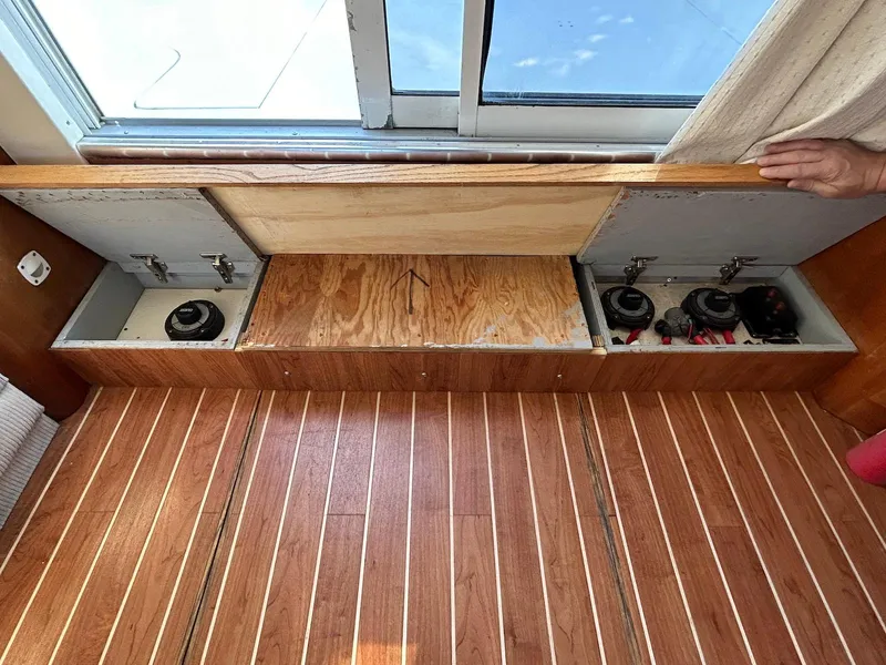 Slide: The Image of Interior view of 1999 Silverton 351 Sedan Cruiser with wooden flooring and storage compartments. - 22