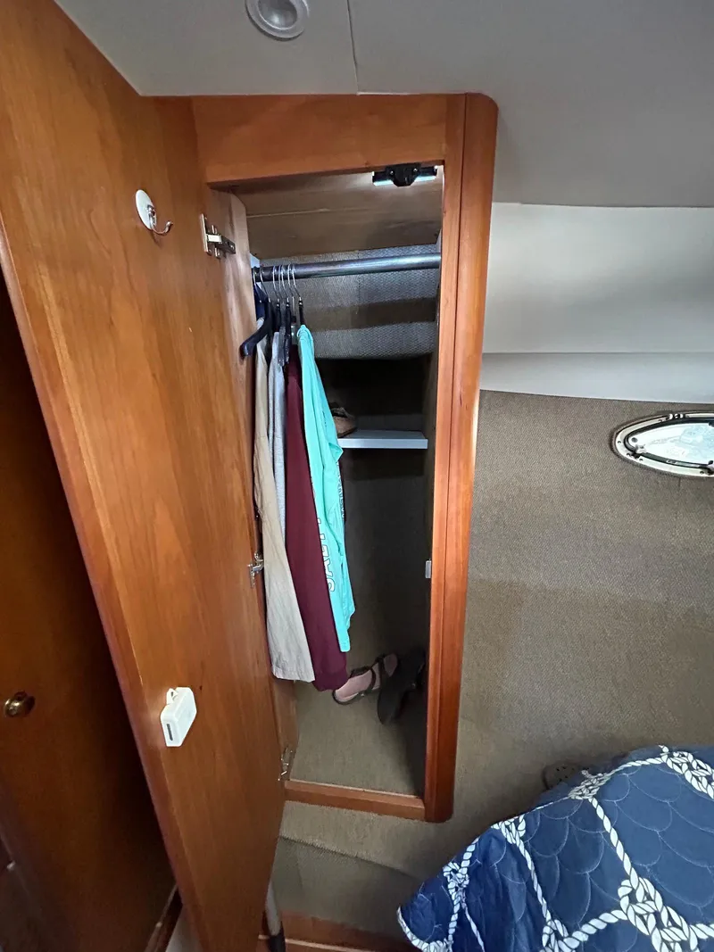 Slide: The Image of 1999 Silverton 351 Sedan Cruiser cabin closet with hanging clothes. - 23