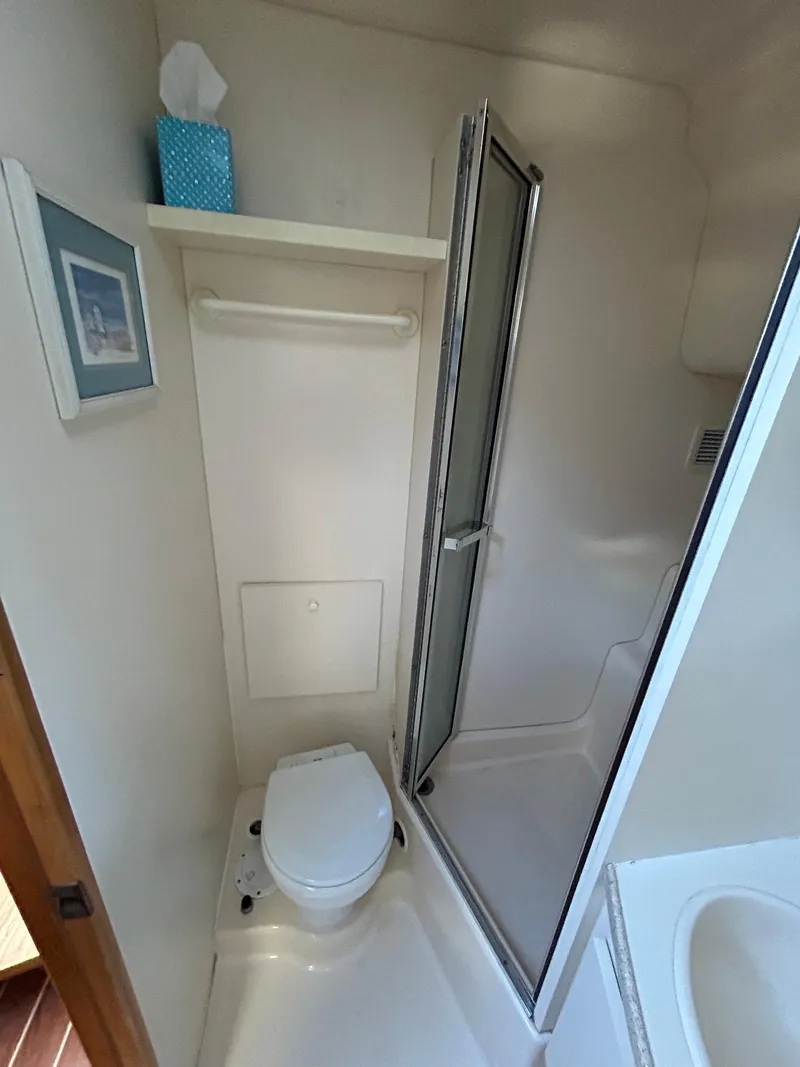 Slide: The Image of 1999 Silverton 351 Sedan Cruiser bathroom with shower and toilet. - 26