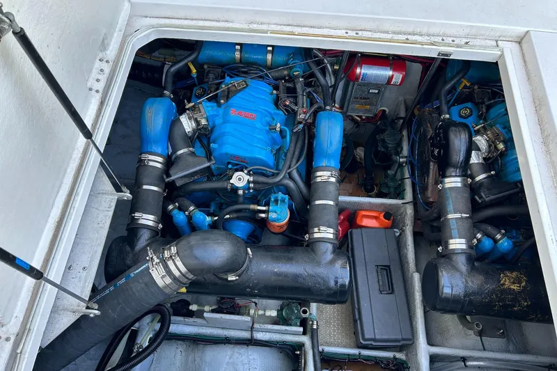Slide: The Image of Engine compartment of 1999 Silverton 351 Sedan Cruiser with blue components and hoses. - 28