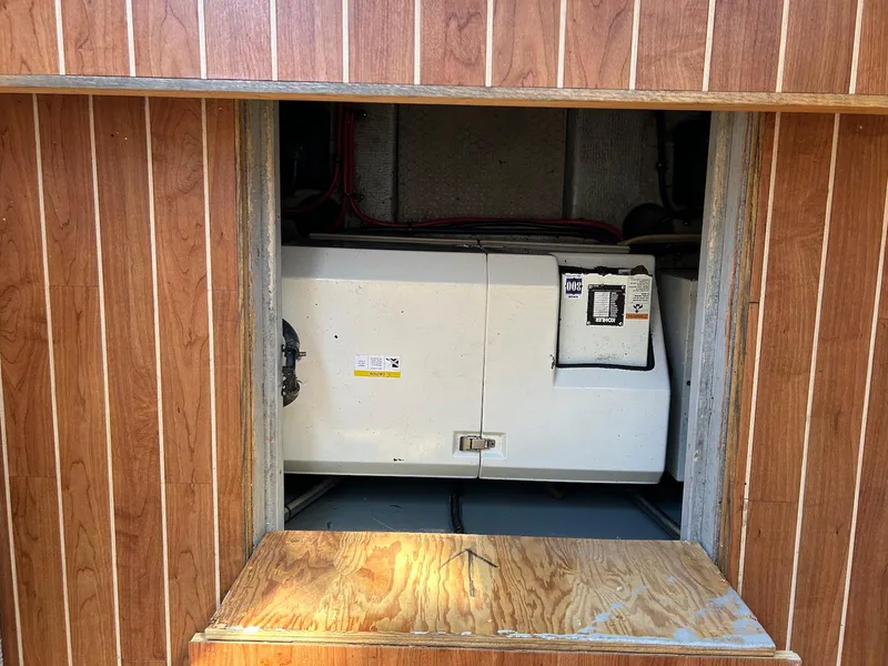 Slide: The Image of 1999 Silverton 351 Sedan Cruiser engine compartment with wooden paneling. - 30