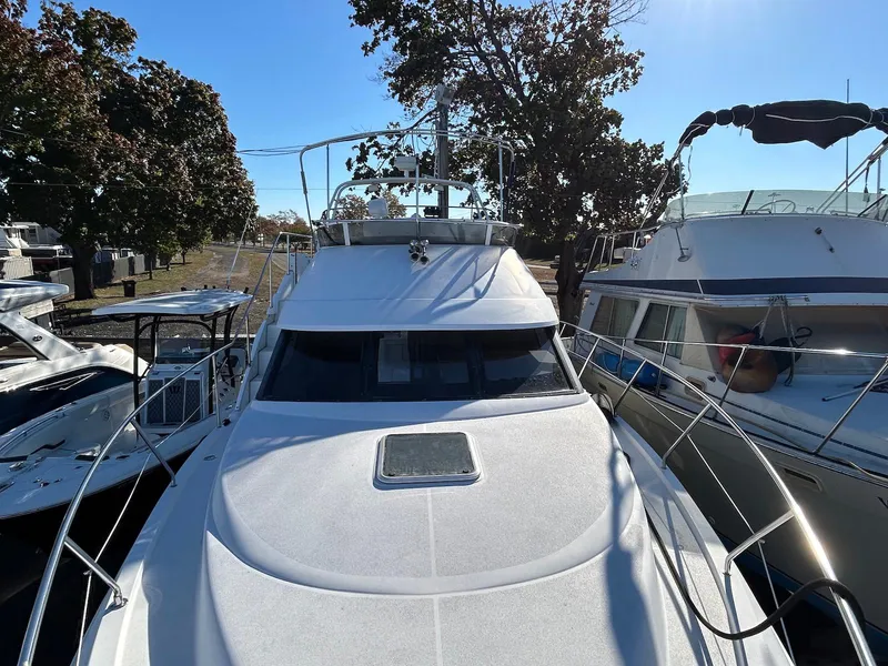 Slide: The Image of 1999 Silverton 351 Sedan Cruiser docked among other boats, sunny day. - 4